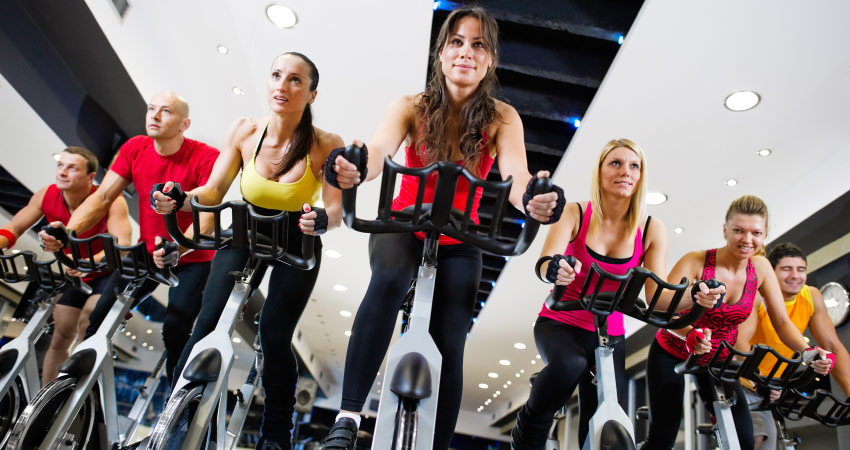 class full of indoor cycling students